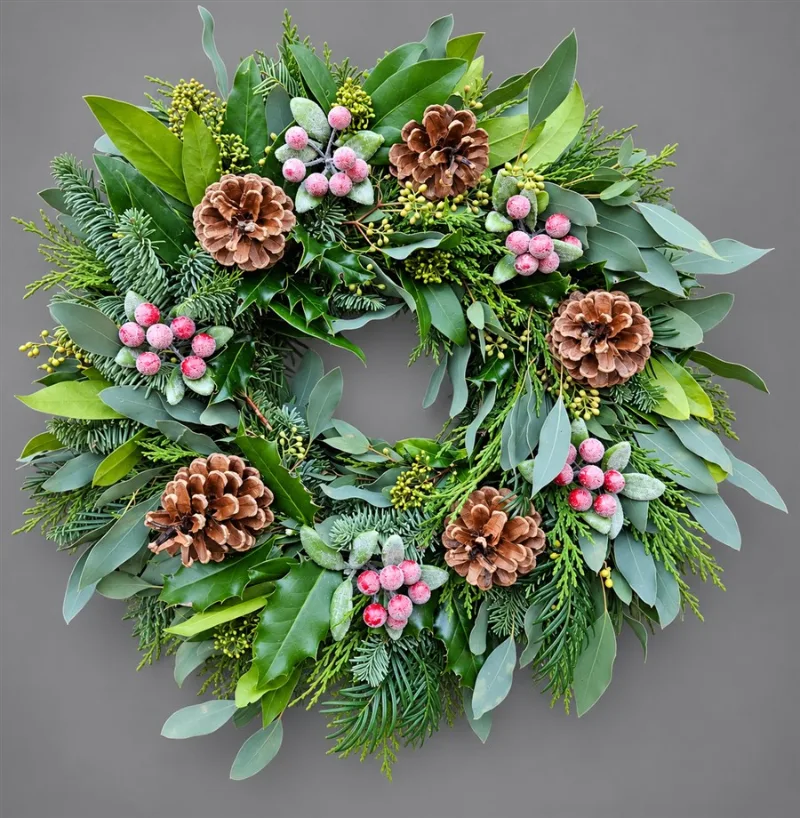 Traditional Mixed Foliage Seasonal Wreath — Handcrafted on a natural mossed wreath ring, this lush design features a rich blend of blue spruce,