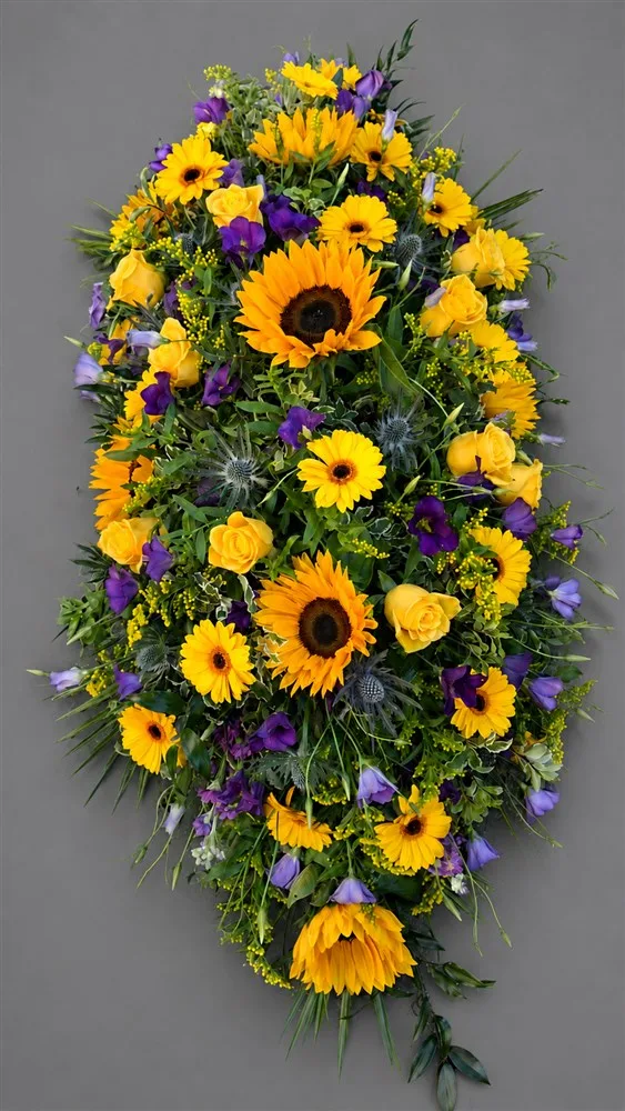 Bright Sunflower Casket Spray — Bold and bright sunflowers with mixed foliages and mixed flowers to create this vibrant casket spray