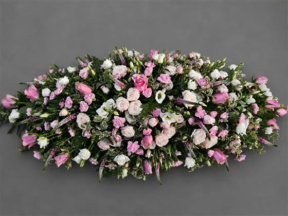 Delicate Seasonal Casket Spray — A selection of roses, carnations, lisianthus, Veronica with delicate greenery to complement. Design 