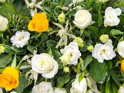 Seasonal Casket Spray — A selection of mixed roses and other seasonal flowers and complementary foliages available at the ti