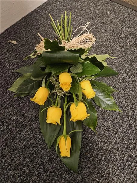 6 Yellow Single Roses tied Sheaf — 6 yellow single roses made into a small tied sheaf with mixed seasonal foliage ideal for a small tok