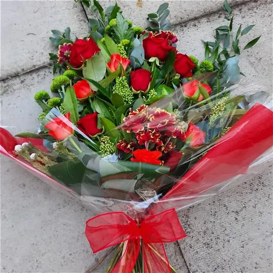 Graceful Red Rose Tied Sheaf — A timeless gesture of sympathy, this bouquet blends classic red roses with the vivid green of chrysa