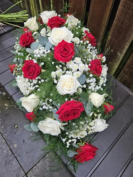 Red & White Rose Single Ended Spray — A classic teardrop shape of red and white large headed roses, gyp and seasonal foliage. Please allow