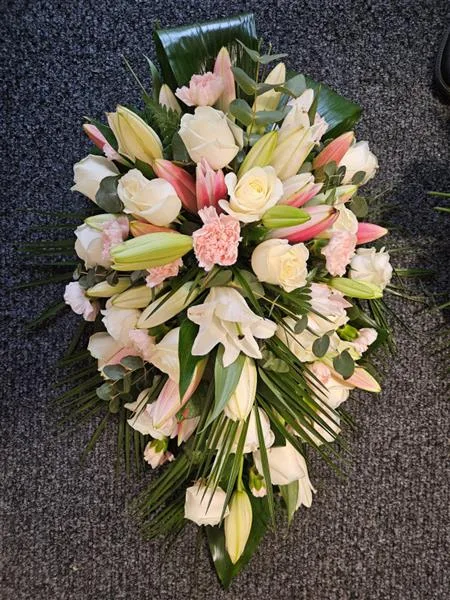 Rose & Lily Graceful Blush and White Oasis Casket Spray — A harmonious blend of soft pink and pristine white creates a gentle expression of sympathy in this c