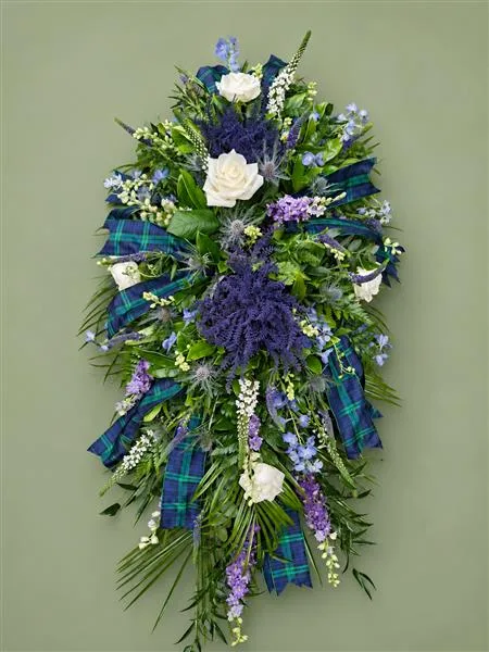 Scottish Themed Single Ended Spray — A classic teardrop shape with a selection of scottish themed flowers including heather and thistle i