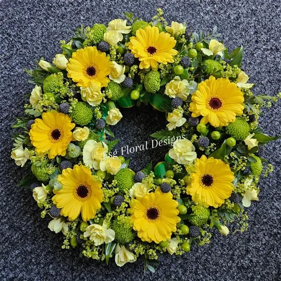 Jamaican themed Wreath Tribute — Mixed flowers in yellow and green finished with the Jamaican colours of green, gold and black ribbon