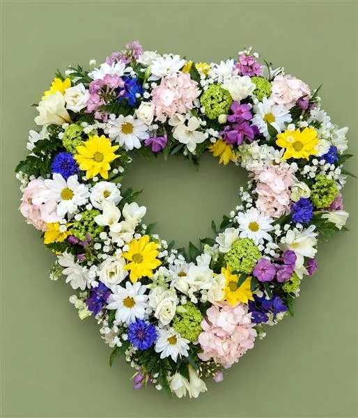 Country Heart — Beautiful and delicate open-heart shaped tribute. Using seasonal flowers. Please allow 2 working day