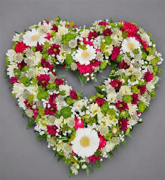 Loose Heart — Beautiful and delicate open-heart shaped tribute. Using seasonal flowers available at the time of or