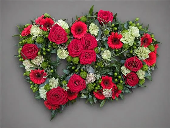 Eternal Double Open Heart — A beautiful twin heart tribute with red roses, red mini gerberas and mint green carnations, interspe
