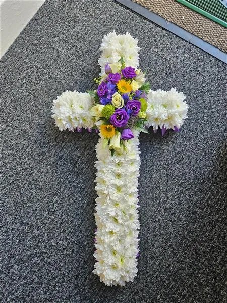 Funeral Cross Tribute — A floral cross tribute is a traditional arrangement of flowers shaped into a cross, often used as a