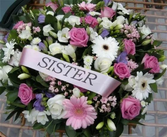 Pink & White Posy Arrangement — This arrangement consists of mixed seasonal pink and white flowers and foliage, finished with a comp