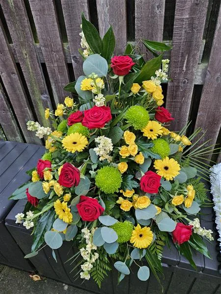 Red, Yellow & Green Pedestal Arrangement — Celebrate a life with the radiant charm of red roses, paired with the soothing presence of green chr