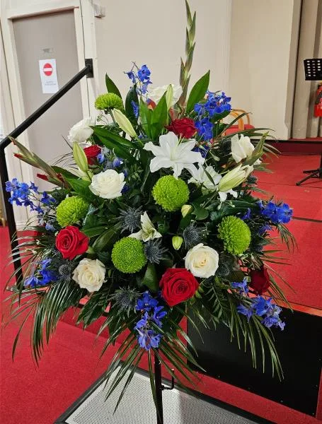 Red, White & Blue Pedestal Tribute — Celebrate a life with the radiant charm of red and white roses, paired with the soothing presence of