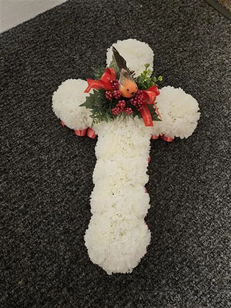 Memorial based Cross — An artificial based cross, shown in white with a festive spray of a robin, red berries and glittered