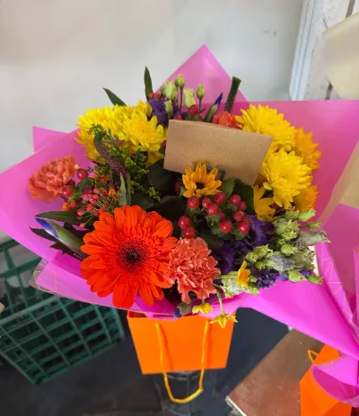 The Sunset — A vibrant, colourful bouquet of orange, yellow, pink and purple, hand-tied.