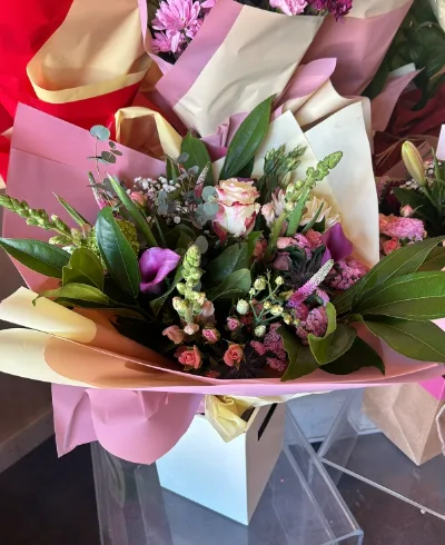 The Wildflower — A loose, garden-gathered bouquet of soft pinks, creams and purples, hand-tied.