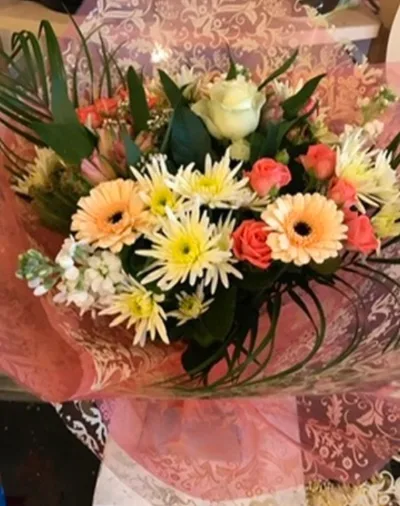 The Peach Melba — Peach and cream gerberas, chrysanthemums and roses, hand-tied in soft pink.