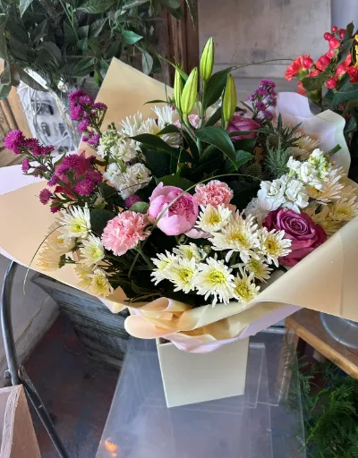 The Garden Party — Pink roses, white lilies and daisies with seasonal foliage, presented in a gift box.