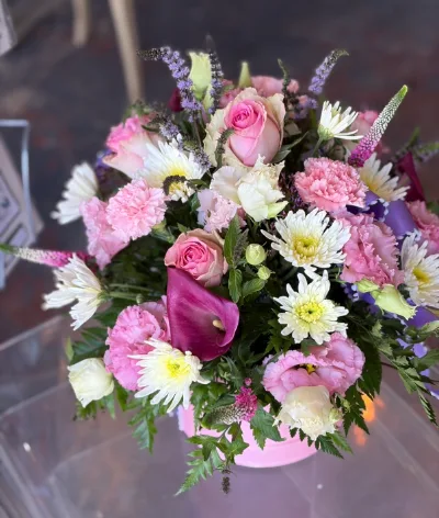 The Pastel Hat Box — Pink roses, carnations, calla lilies and white chrysanthemums arranged in a pink hat box.