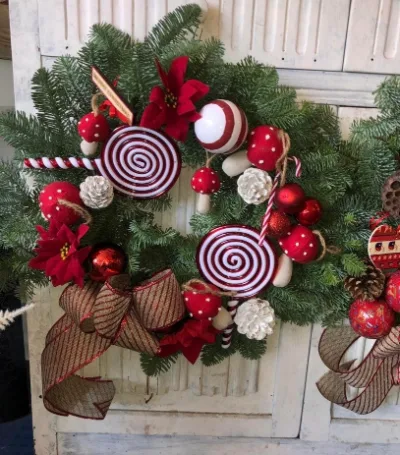 The Candy Cane — A playful wreath with candy lollipops, poinsettias, red toadstools and pine cones.