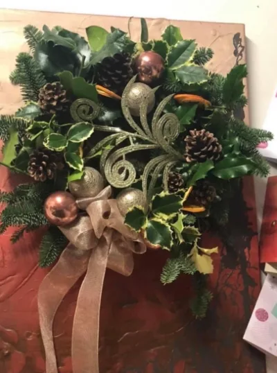 The Copper — Fresh foliage with copper baubles, pine cones and a golden swirl, finished with a copper ribbon.